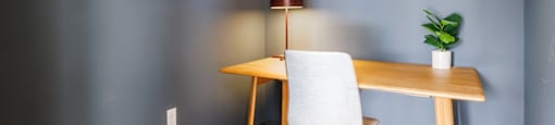 a desk and a chair in a room with blue walls