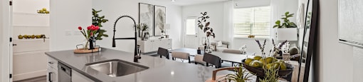 A modern kitchen with a large island and a sink.