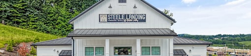 A Steele Landing building with a parking lot in front.