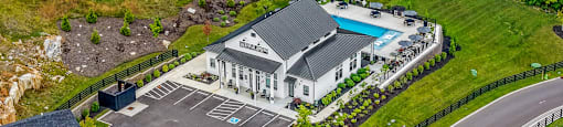 A large house with a pool and a driveway.