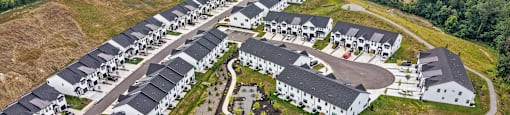 A bird's eye view of a housing development with a central playground.