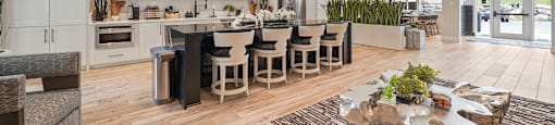A modern kitchen with a dining table and chairs.