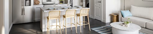 A modern kitchen with a dining table and chairs.