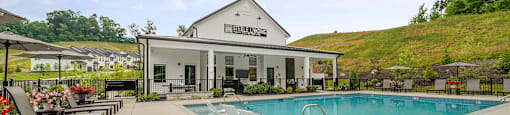 A pool area with a building in the background.