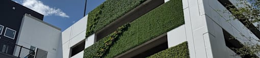 A modern building with a green wall on the side.