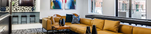 a living room with couches and tables and a large window