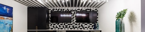 a bar with four stools in front of a counter with black stools