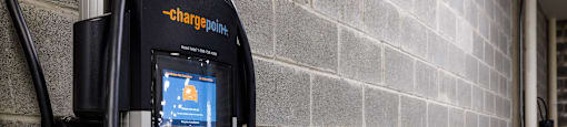 a gas pump sitting next to a brick wall
