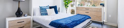 a bedroom with a bed and a large window
