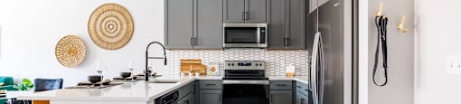 a kitchen with stainless steel appliances and a white counter top
