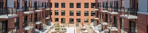 an aerial view of a courtyard with tables and chairs