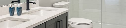 a bathroom with a toilet and a sink and a shower