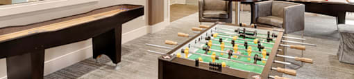 Billiard and gaming room with table and chairs, Foosball table, Shuffleborad table, billiards