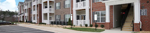 Apartment buildings with patio or balcony; parking lot
