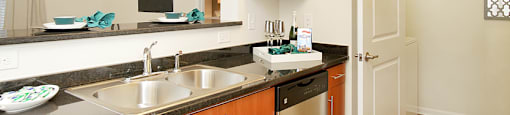 Kitchen with stainless steel appliances; open to living room