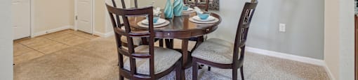 A dining room with a table set for two.