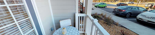 Private patio off the living room with table and two chairs