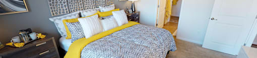 Bedroom with carpet; door to bathroom and closet