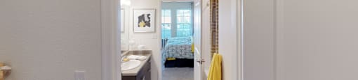 Walk-in closet leading into bathroom; inside main bedroom