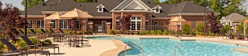 Resort-style pool with chairs, umbrellas
