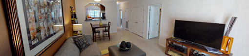Living room with ceiling fan; opening to kitchen