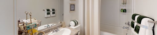 Hallway bathroom with sink, toilet, shower and tub