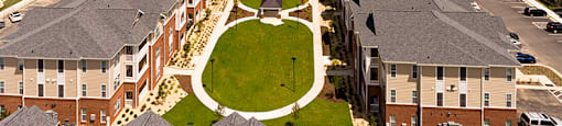 Aerial view of apartment buildings with paved pathways throughout