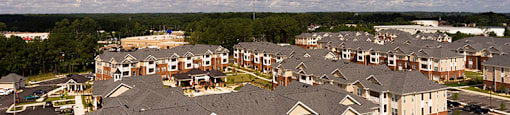 Aerial view of apartment buildings and parking lot