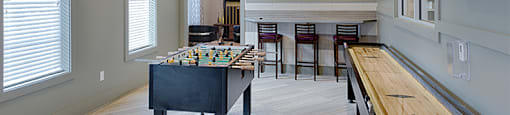 Game room with foosball table, shuffleboard, flat screen TVs