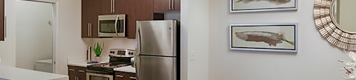Kitchen with stainless steel appliances; open to dining room