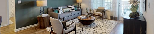 Living room with couch and chair; door to patio or balcony