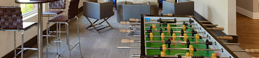 Game room with TV, chairs, tables and foosball