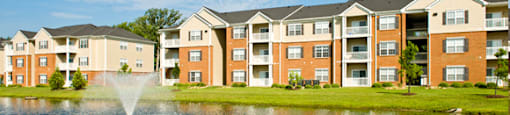 Apartment buildings overlooking pond and fountain