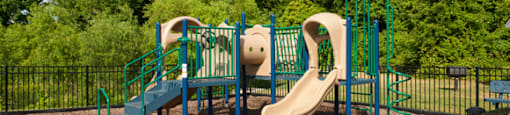 Playground surrounded by fence and trees