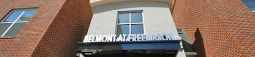 Belmont at Freemason leasing office entrance with community sign over doors