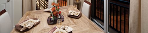 Corner apartment with dining table and chairs; overlooking the city