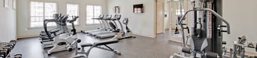 Fitness center with cardio and resistance training equipment; free weights; adjoining playroom