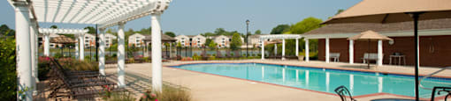 Pool With Cabanas and Chairs
