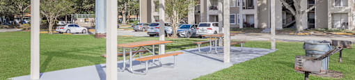 a picnic area with a grill in a park