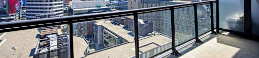 A balcony overlooks a cityscape with tall buildings.