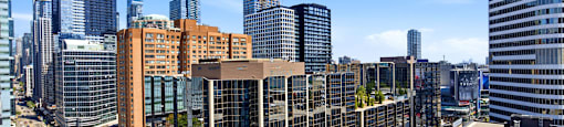 A cityscape with tall buildings and a clear sky.