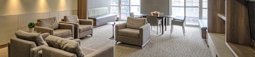 A spacious waiting room with comfortable seating and a television.