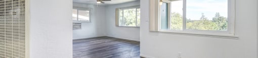 A room with a ceiling fan and a window.