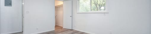 A room with a window and a door.