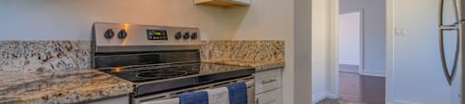 A kitchen with a stove top oven and microwave above it.