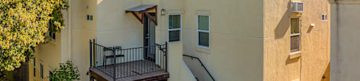 A building with a balcony and stairs.