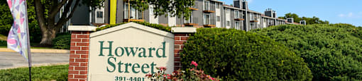 A sign that says Howard Street in front of a building.
