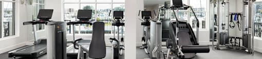 A gym with a variety of equipment including treadmills, weights, and exercise machines at The Port at East Beach Apartments and Marina in Virginia, 23518