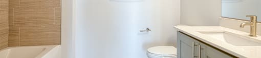 a bathroom with a sink and a toilet and a shower at The Port at East Beach Apartments and Marina, Virginia