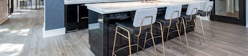 A modern kitchen with a white countertop and black cabinets.